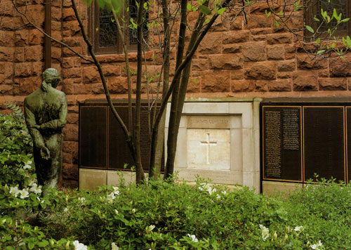 Statue of Jesus Christ in memorial garden with white azaleas