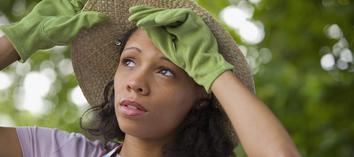 Gardener wearing hat in hot weather